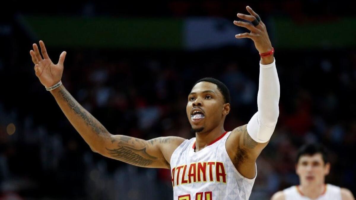 Hawks forward Kent Bazemore (24) reacts after a late basket in the second half of a game against the Washington Wizards on April 24.