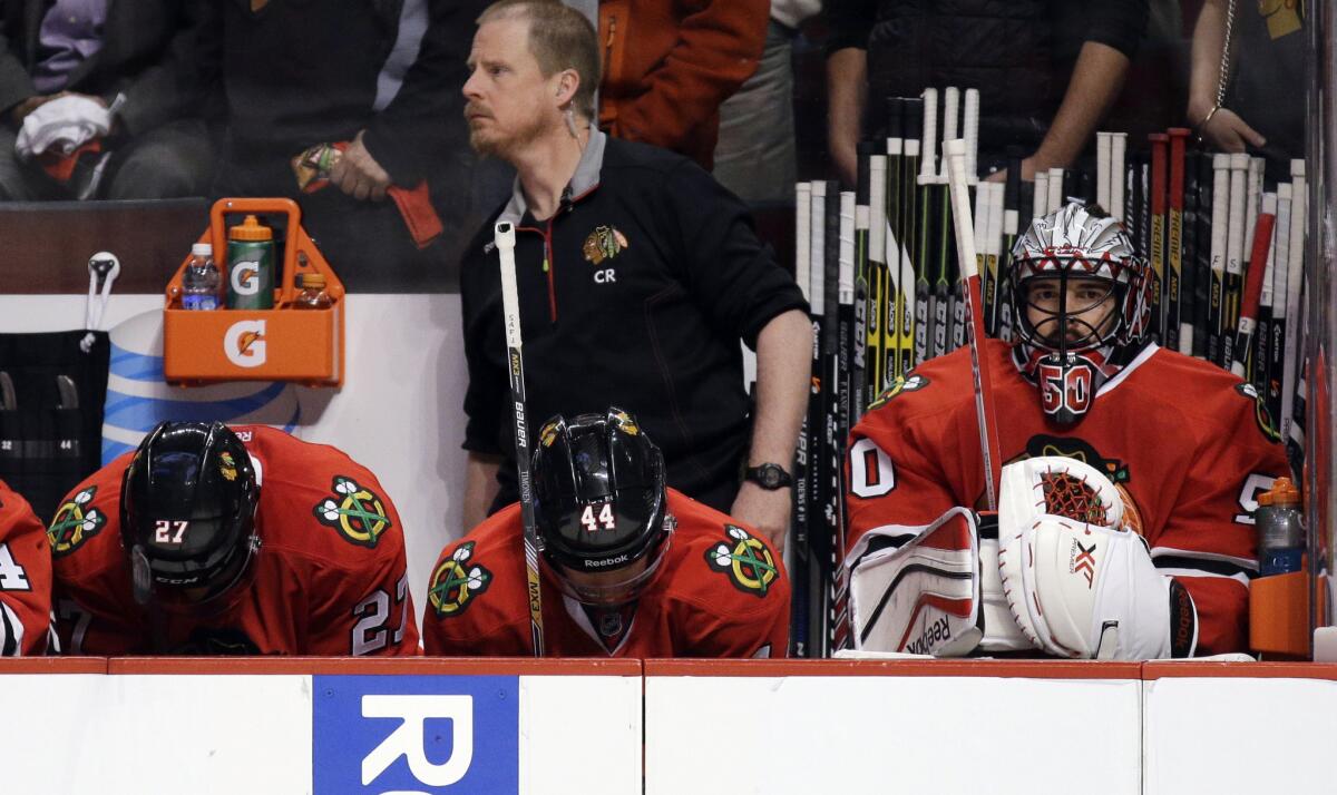 Chicago Blackhawks players look down near the end of Game 3 of the Western Conference finals against the Ducks.
