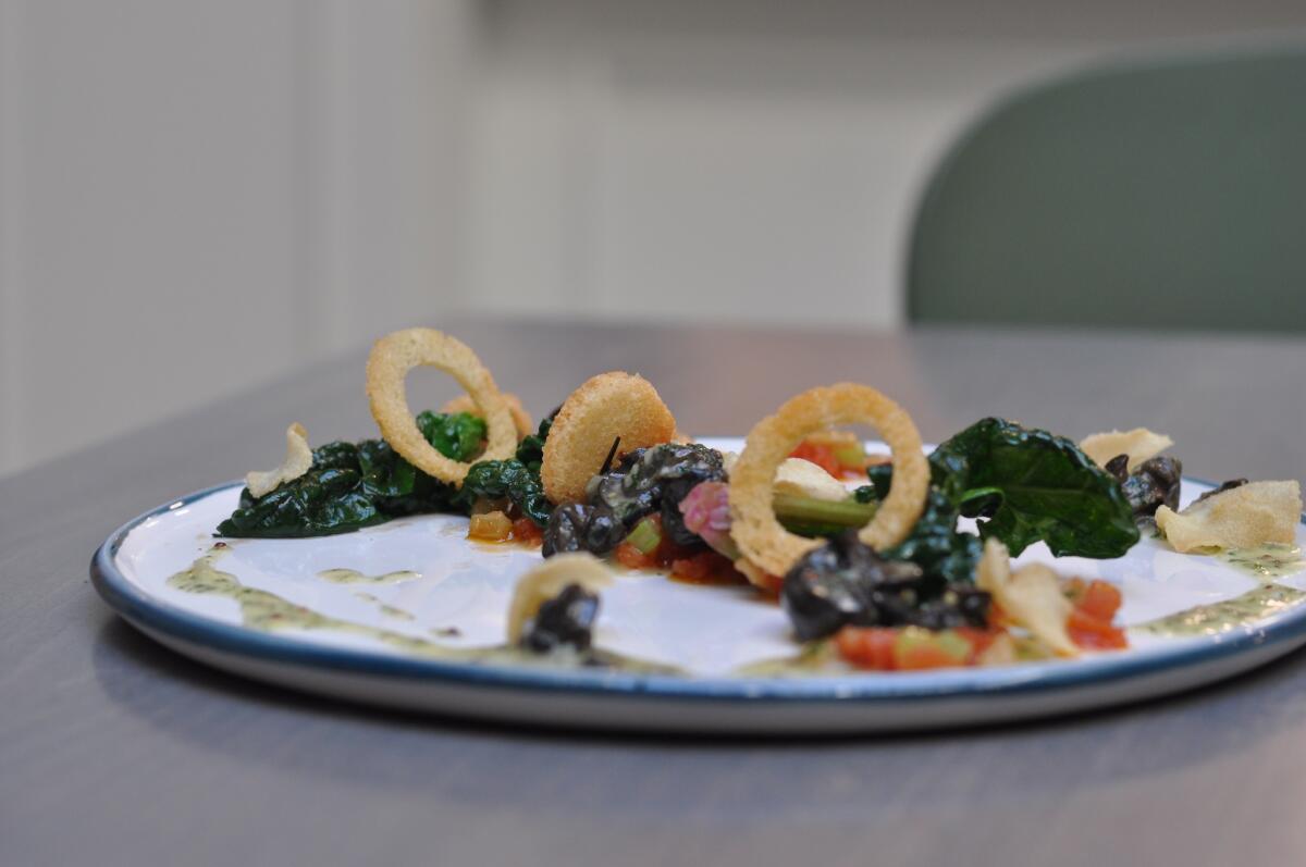 Escargot Provencal, with wild Burgundy snails, tomato, fennel, persillade and crostini, at Spring, the French restaurant that opens Monday in downtown Los Angeles.