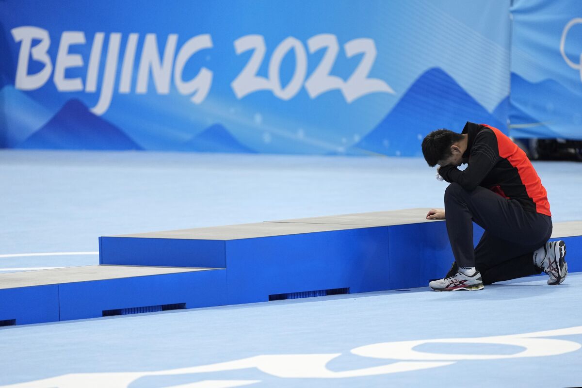 Gao Tingyu of China reacts after winning the gold medal and setting an Olympic record in the men's speedskating 500-meter race at the 2022 Winter Olympics, Saturday, Feb. 12, 2022, in Beijing. (AP Photo/Ashley Landis)