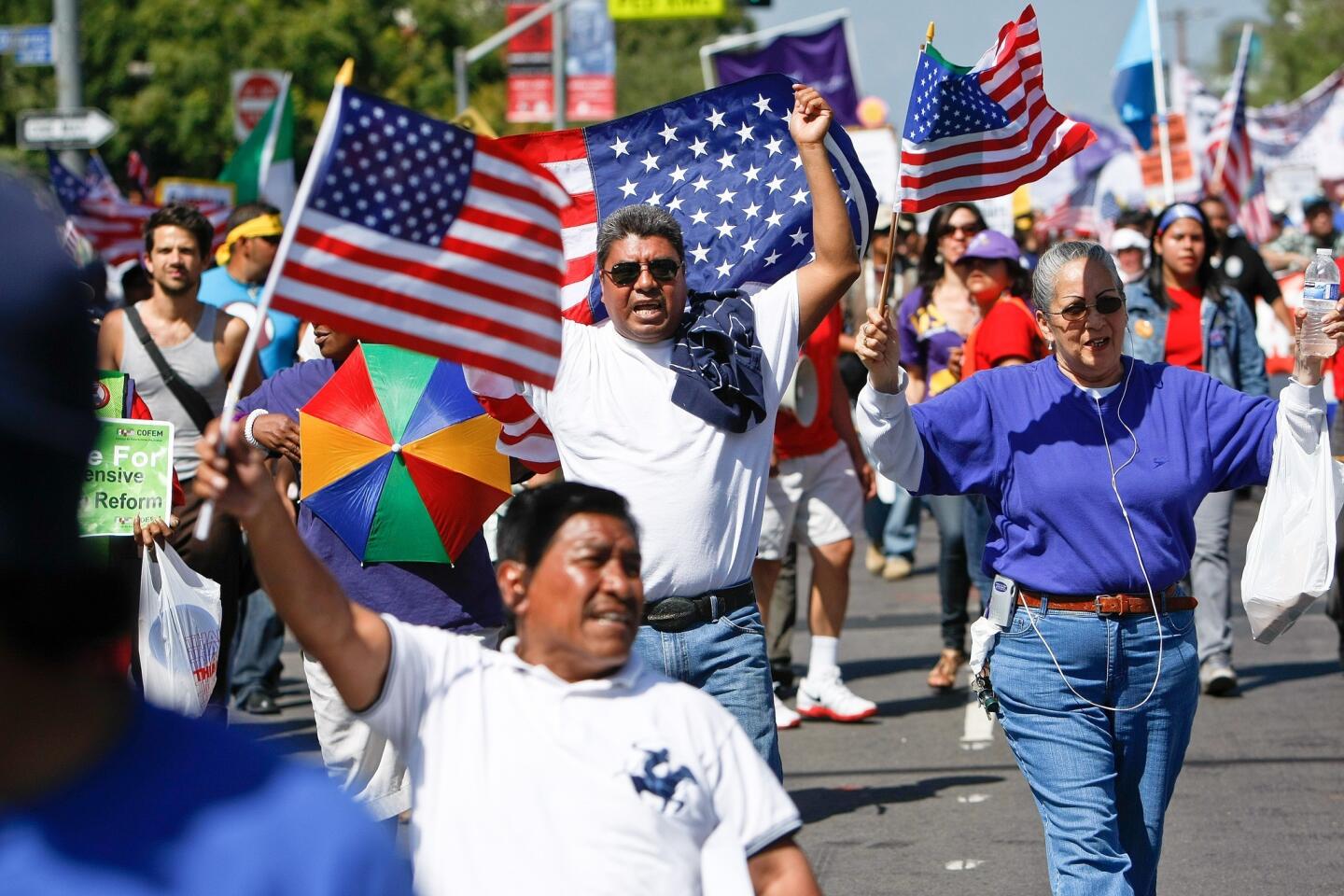 People make their way along Paseo de la Plaza in downtown Los Angeles at the conclusion of a May Day march for immigration reform.