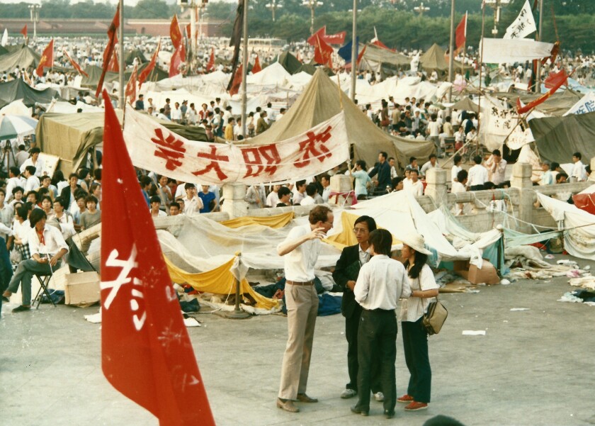 Then-Times bureau chief David Holley, center with hand raised, interviews people in Tiananmen Square during the seven weeks of protests in 1989.