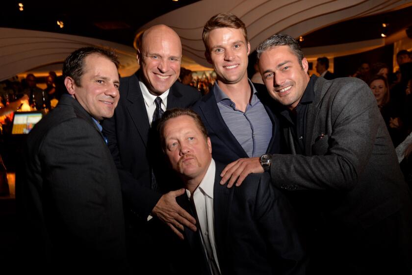 Actors, top from left, Tony Ferraris, Randy Flagler, Jesse Spencer and Taylor Kinney surround Christian Stolte as they attend a premiere party for NBC's "Chicago Fire," "Chicago P.D." and "Chicago Med" at STK Chicago on Nov. 9.