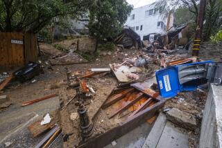 A home is damaged by a storm is seen on Caribou Ln during a rainstorm in the Beverly Crest neighborhood 