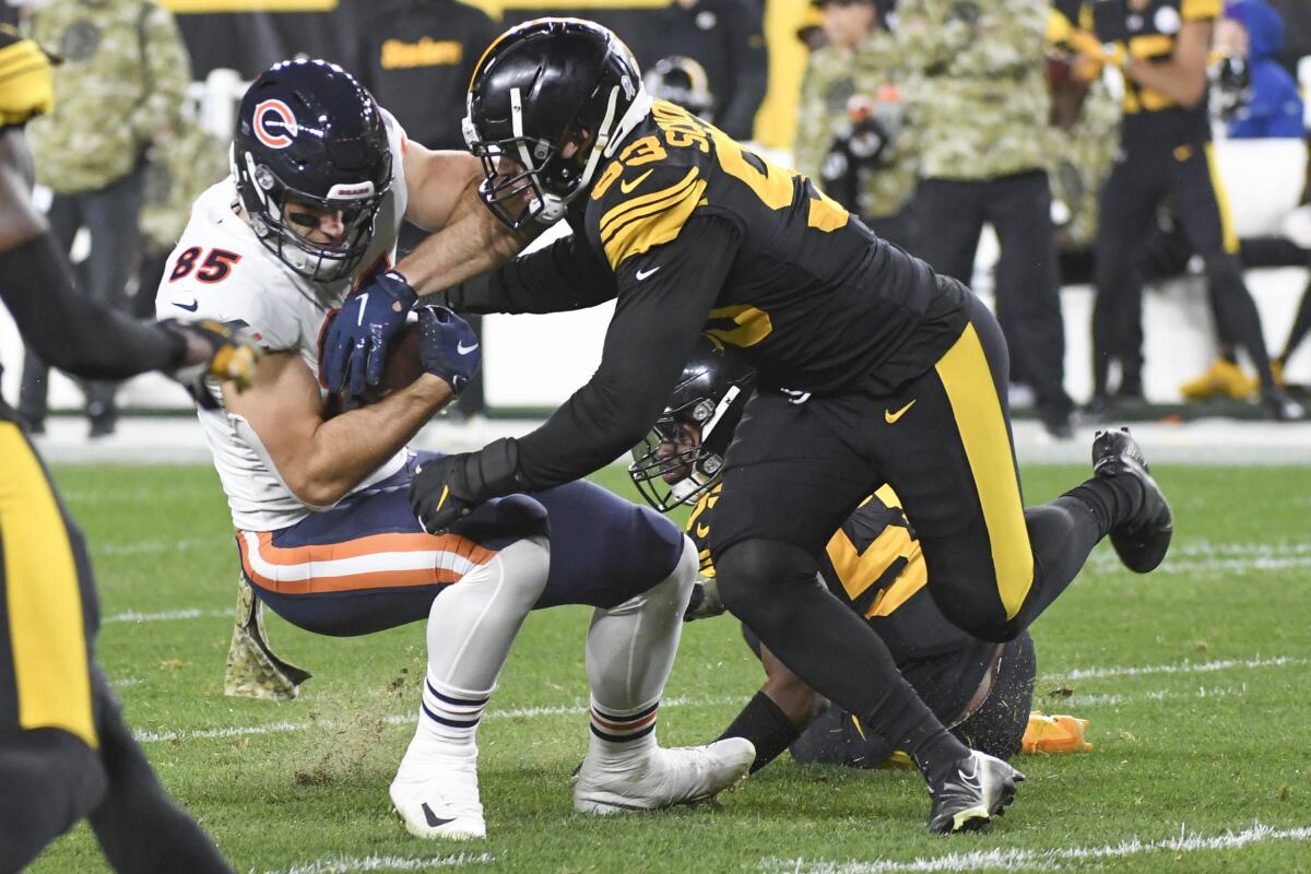 Pittsburgh Steelers cornerback Joe Haden (23) tackles Chicago Bears tight end Cole Kmet (85) during the first half of an NFL football game, Monday, Nov. 8, 2021, in Pittsburgh. (AP Photo/Fred Vuich)