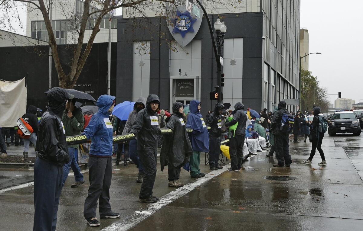 Protesters chained together June 1 block an intersection in front of the Oakland Police Department.