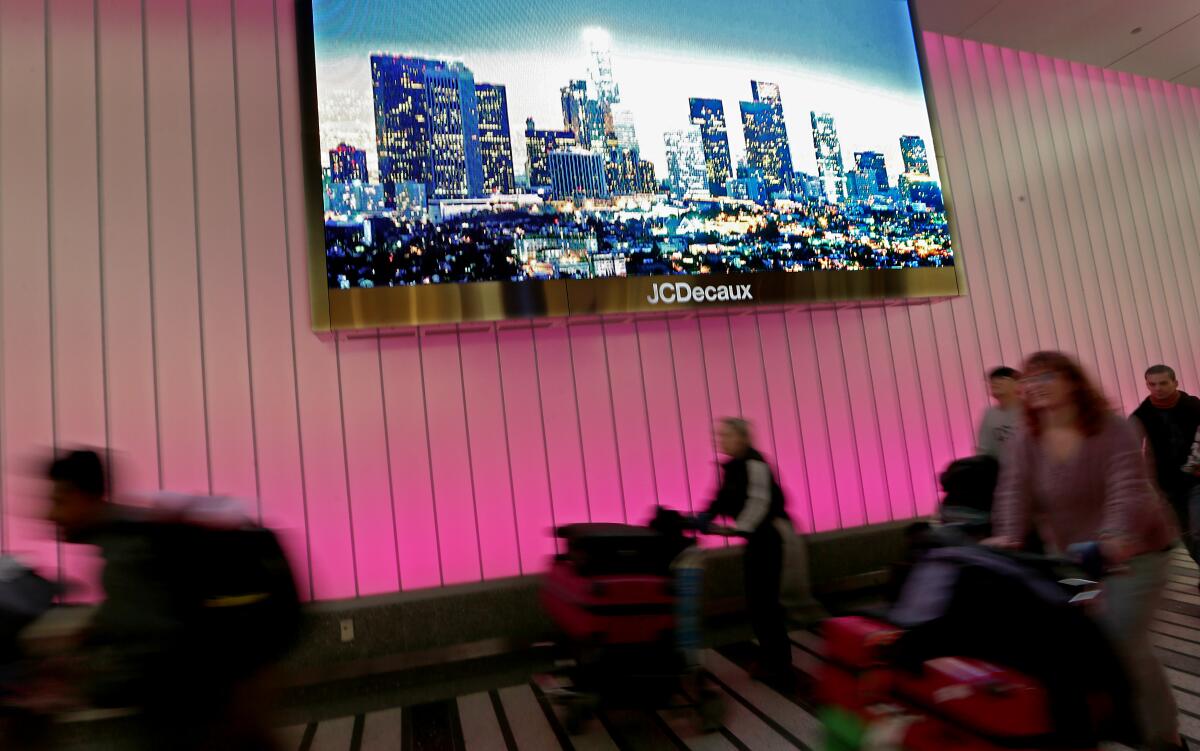 Travelers arrive at Tom Bradley international terminal.