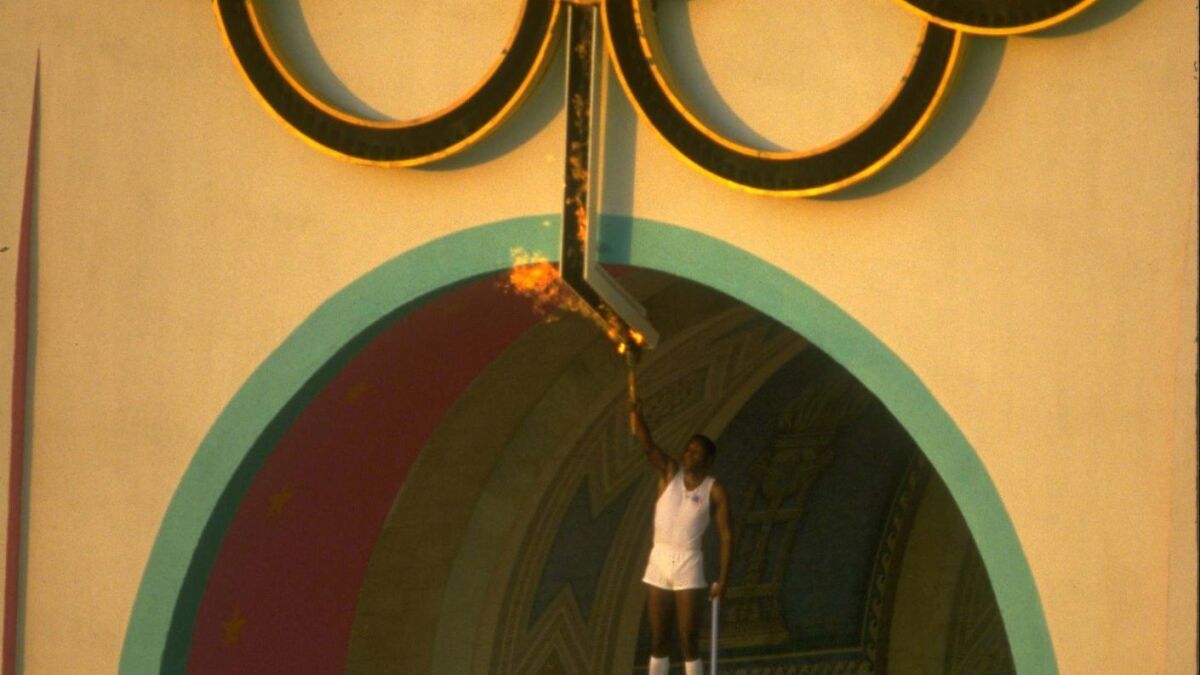 Rafer Johnson holding the Olympic torch in 1984
