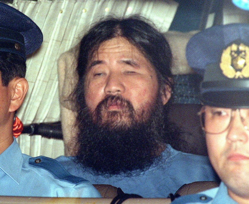 In this Sept. 25, 1995, file photo, Japanese doomsday cult leader Shoko Asahara, sits in a police van following an interrogation in Tokyo.