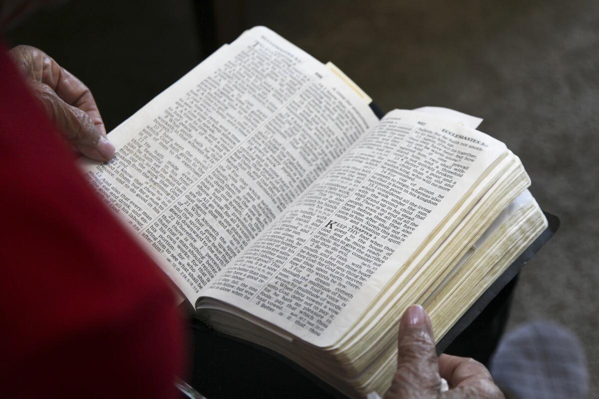 An open Bible on a woman's lap