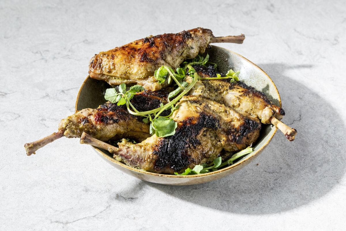A bowl of grilled rabbit legs