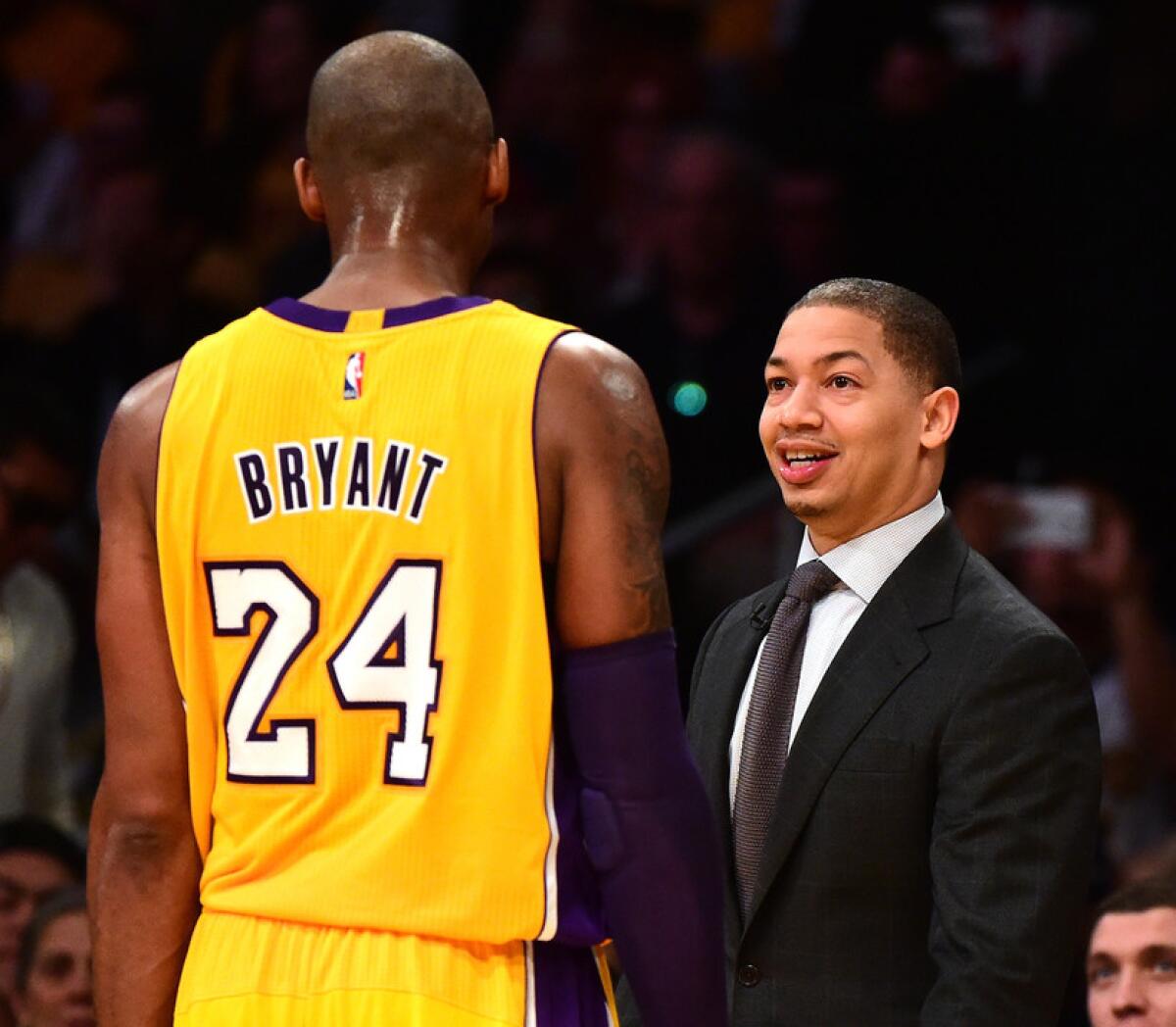 Lakers star Kobe Bryant and Cavaliers coach Tyronn Lue exchange greetings before a game in 2016.