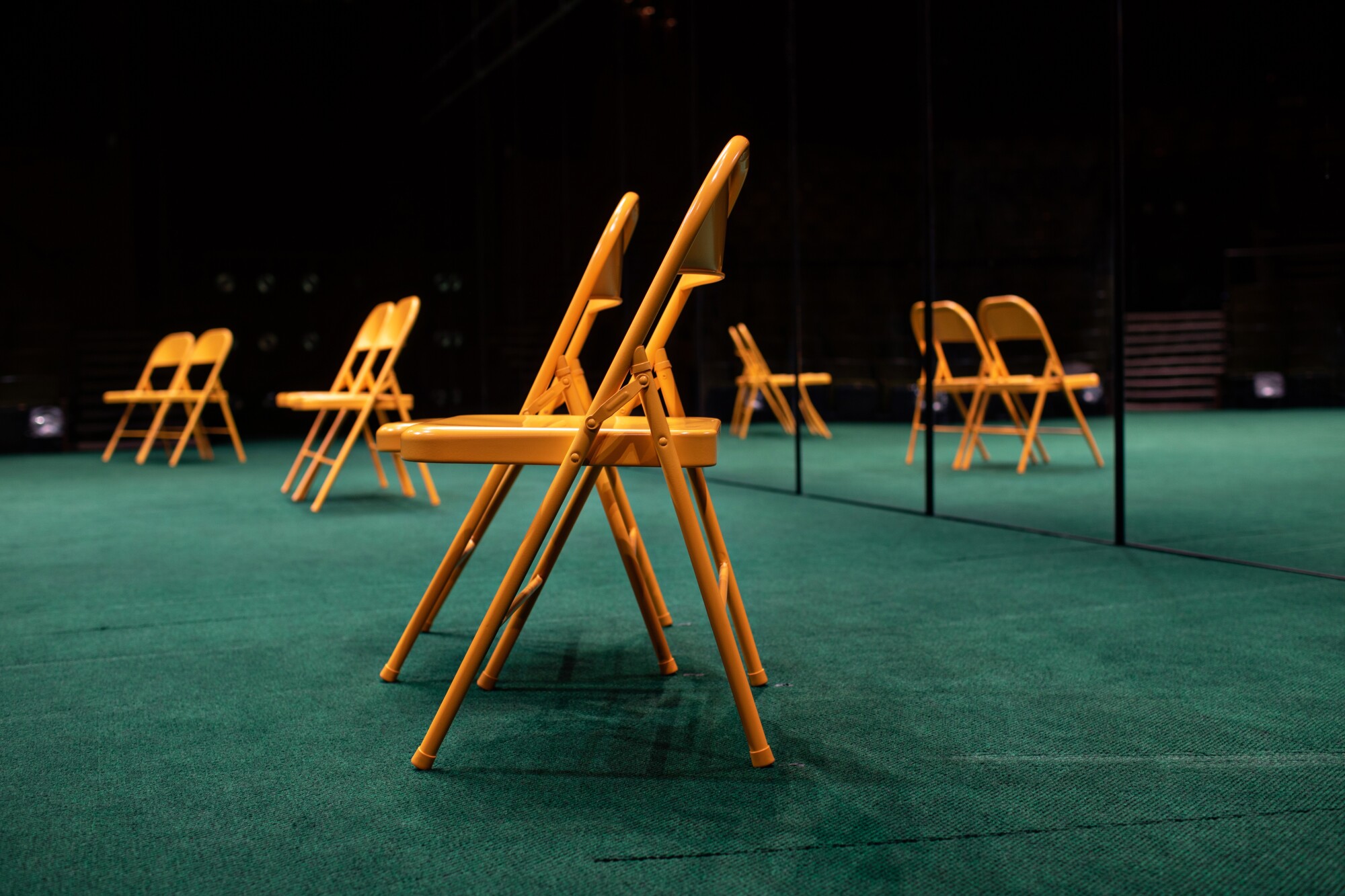 Yellow folding chairs are used during the counseling scene in the play.