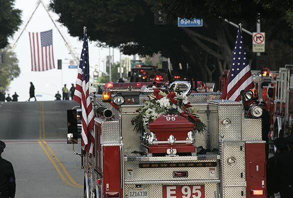 The casket of L.A. City firefighter Brent Lovrien is carried to the Cathedral of Our Lady of Angels in Los Angeles. Lovrien was killed last week in an explosion. This is the fire engine that he served on.