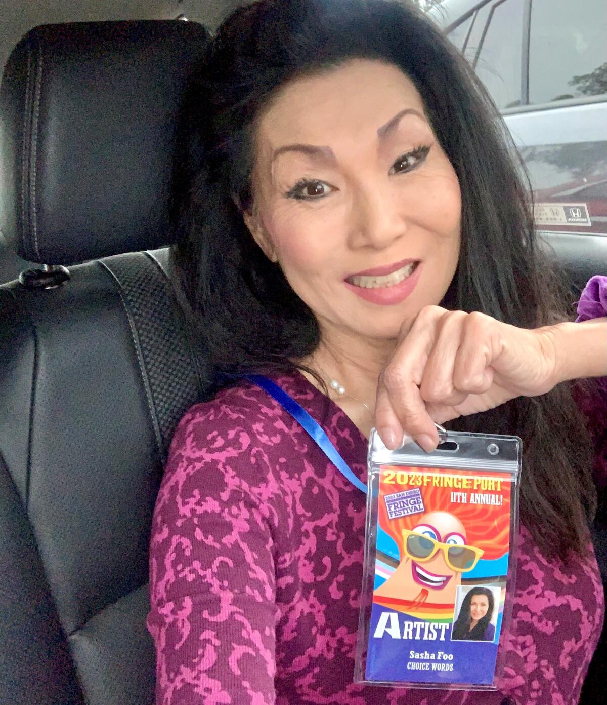 Sasha Foo, TV reporter-turned-playwright, shows her credential for the 2023 Fringe Festival where her play was well received.