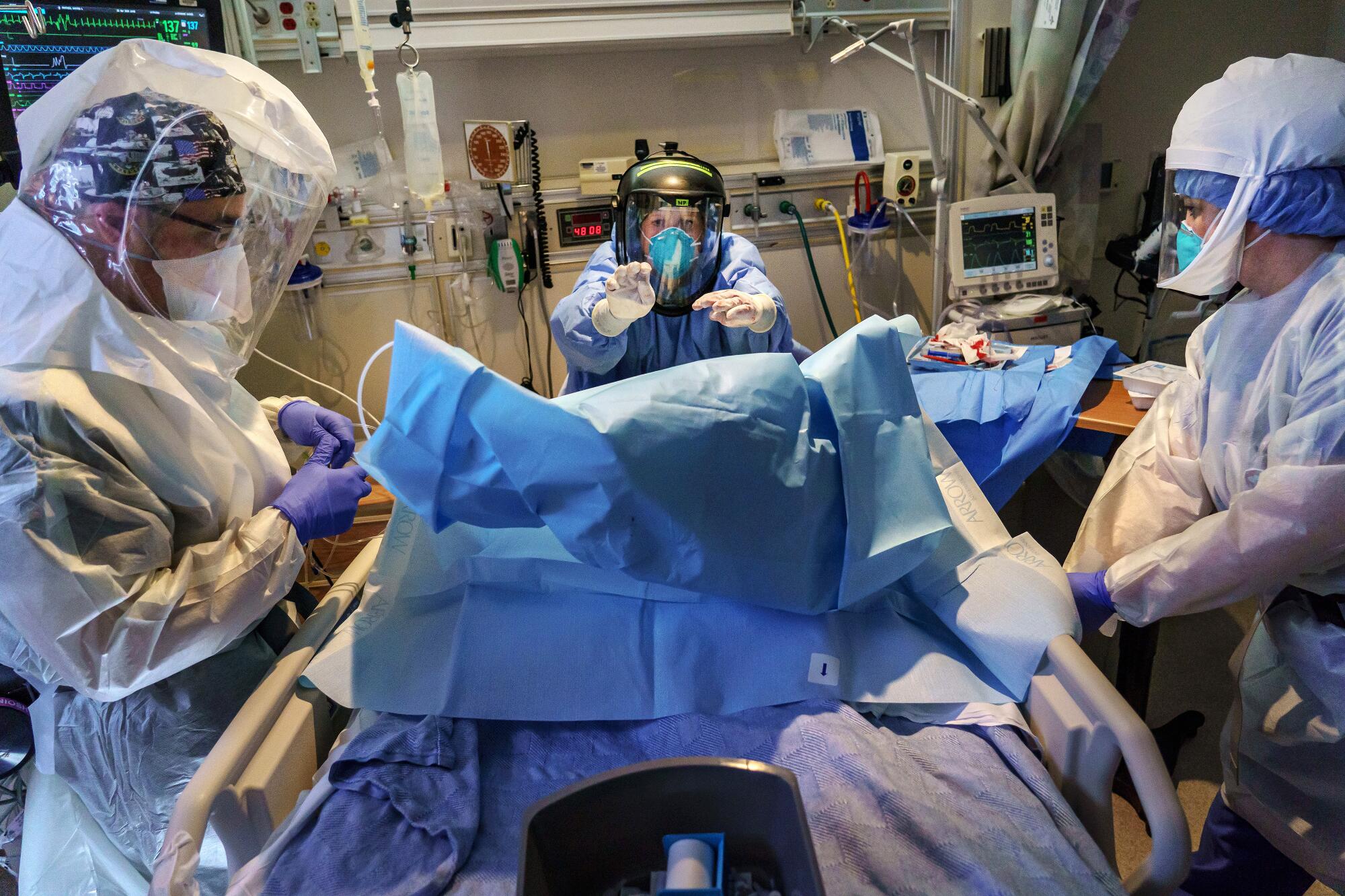 Saul Reynoso, Charlotte Thomas, Sandra Sandoval work on a patient.