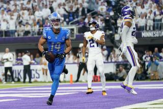 Detroit Lions wide receiver Amon-Ra St. Brown (14) celebrates after catching a 1-yard touchdown pass during the second half of an NFL football game against the Minnesota Vikings, Sunday, Dec. 24, 2023, in Minneapolis. (AP Photo/Abbie Parr)