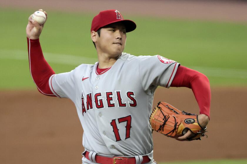 Los Angeles Angels starting pitcher Shohei Ohtani throws to an Atlanta Braves.