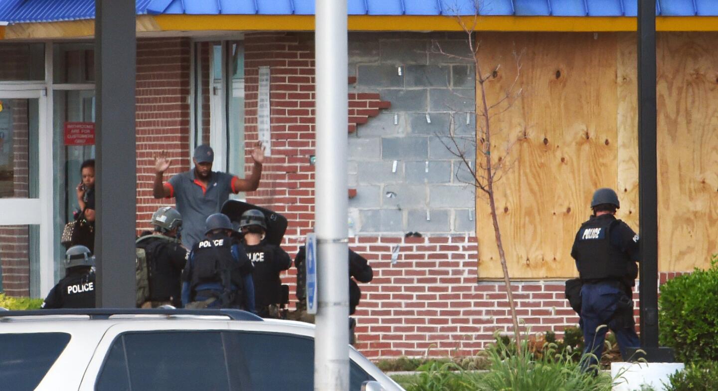 A suspect surrenders to Baltimore City police after a five-hour stand-off inside a Burger King restaurant at Washington Blvd., and Monroe Street.