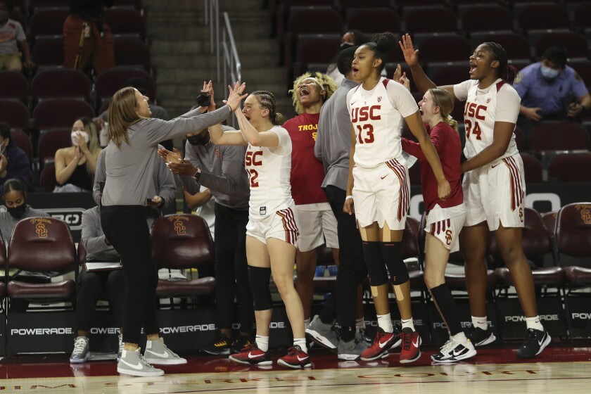 USC coach Lindsay Gottlieb, left, and players celebrate after a victory over previously undefeated Arizona on Sunday.