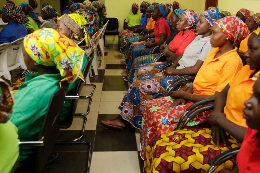 FILE - In this Monday, May 8, 2017 file photo, Chibok schoolgirls, recently freed from Nigeria extremist captivity, are photographed in Abuja, Nigeria. Another Nigerian schoolgirl seized in a mass abduction by Boko Haram extremists from a boarding school nearly four years ago has been found, authorities announced Thursday Jan. 4, 2018. The kidnapping resulted in global outrage and drew attention to the thousands of Nigerians who have been taken by Boko Haram during its deadly insurgency over the years. (AP Photo/Sunday Alamba, File)