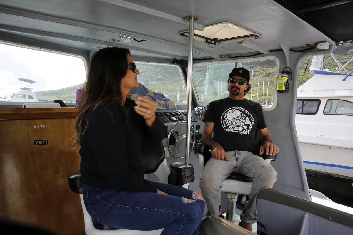 Cynthia and Lance Keener sit on their boat on the island of Kauai.