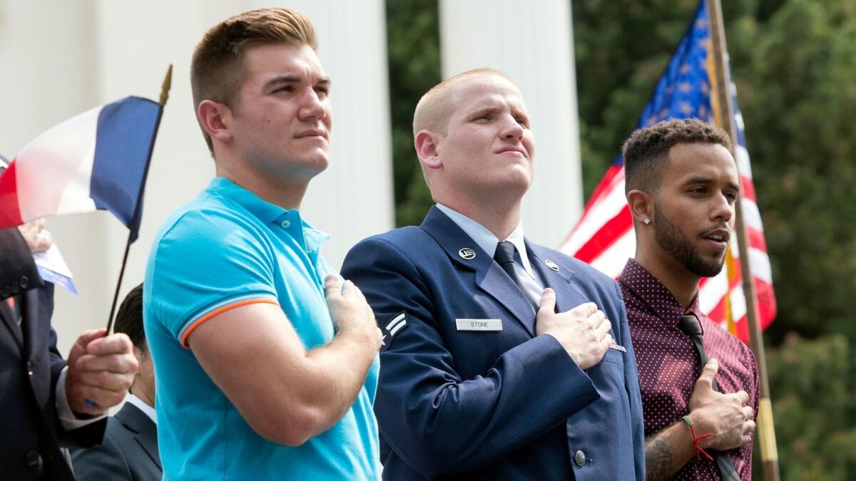 From left, Oregon National Guardsman Alek Skarlatos, U.S. Airman Spencer Stone and Anthony Sadler attend a parade in Sacramento on Sept. 11, 2015.