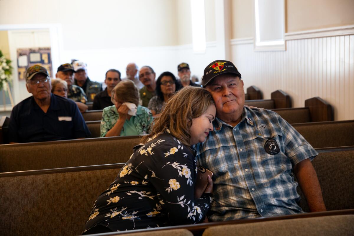 Gena Valencia sits with her father Ruben Valencia while watching a video that honors best friend Raul Guerra. (Dania Maxwell / Los Angeles Times)