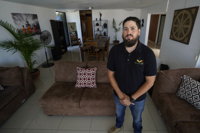 Tijuana, Baja California - August 27: Standing in the living room Jose Inzunza 30 years old, paramedic works for Nouvelle Vie at Colonia El Mirador on Friday, Aug. 27, 2021 in Tijuana, Baja California. (Alejandro Tamayo / The San Diego Union-Tribune)