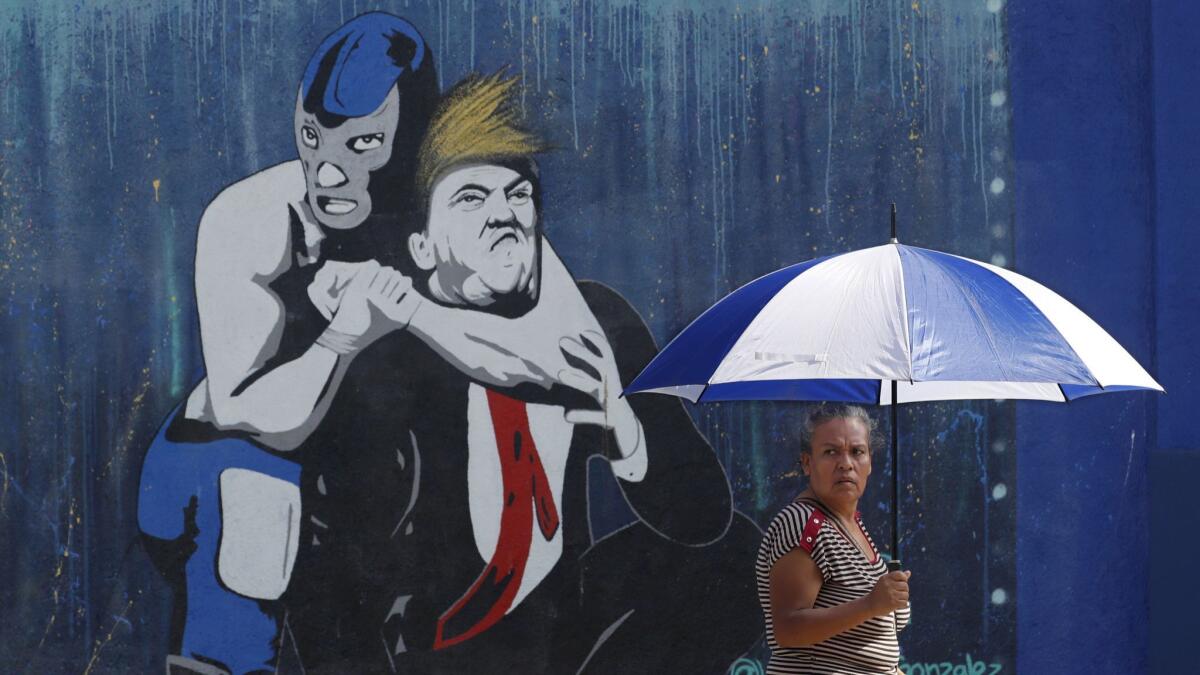 A Boyle Heights mural depicts a luchador putting President Trump in a headlock.
