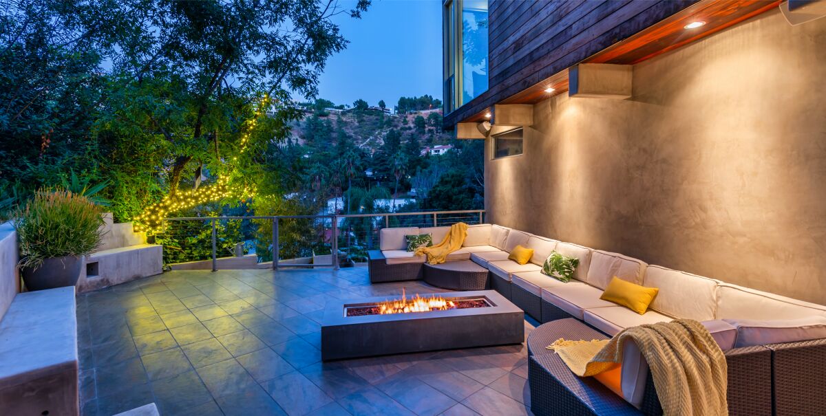 Jacqueline MacInnes Wood's secluded two-story home takes in canyon views from a balcony and a patio with a firepit.