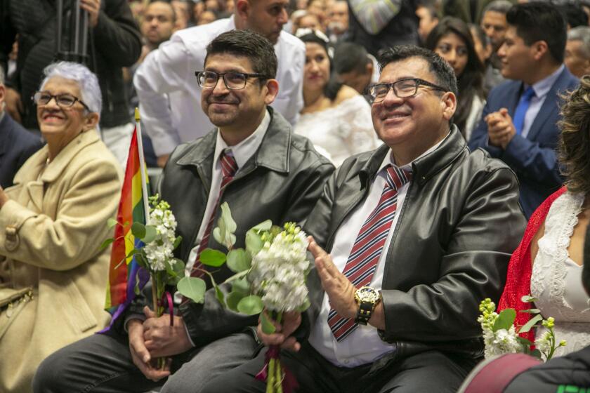 L-r, Jose Juan Murillo and Alonso Osuna, who have been together for 10 years, were among the 1,500 couples married during a mass wedding ceremony at the Municipal Auditorium in Tijuana on Valentines Day, Friday, February 14, 2020. This was the first time that same-sex couples were allowed to participate in the annual event.