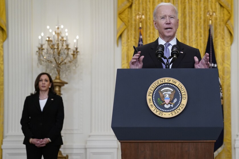 Vice President Kamala Harris listens as President Joe Biden speaks about distribution of COVID-19 vaccines, in the East Room of the White House, Monday, May 17, 2021, in Washington. (AP Photo/Evan Vucci)