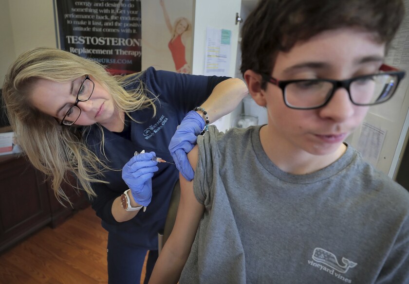 A 15-year-old gets a flu shot in Memphis. The second surge in flu cases this year began in late January.