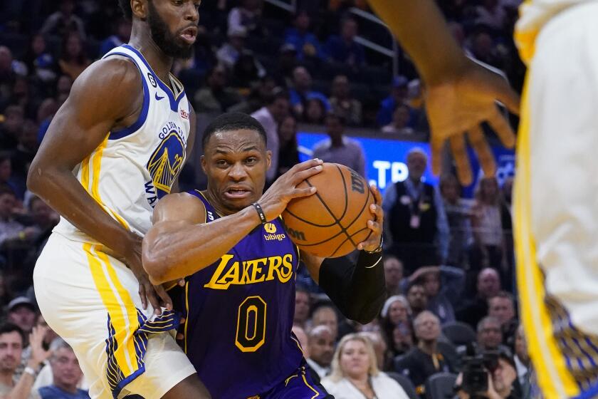 Lakers guard Russell Westbrook drives to the basket past Warriors forward Andrew Wiggins 