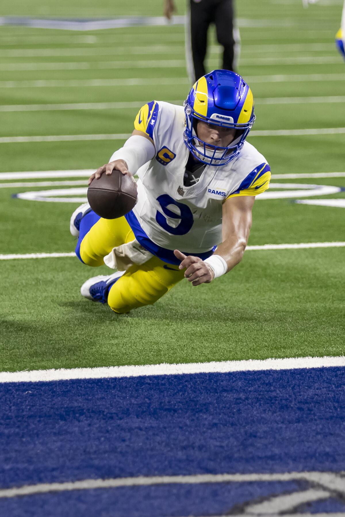 Rams quarterback Matthew Stafford (9) dives for a two-point conversion against the Dallas Cowboys.