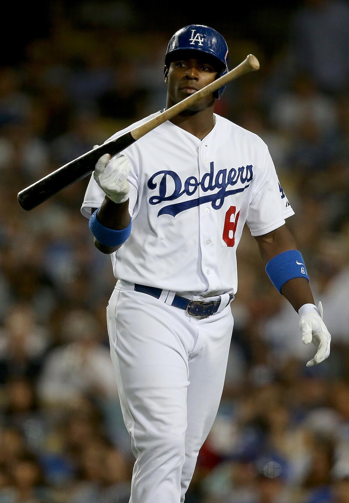 Dodgers right fielder Yasiel Puig twirls his bat after striking out in the fifth inning of a 3-2 loss to the Chicago Cubs on Tuesday.
