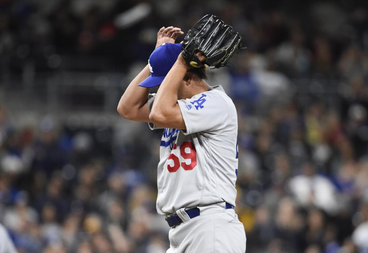 Dodgers relief pitcher Chin-Hui Tsao (59) reacts after walking a batter during the 11th inning against the Padres on May 21.