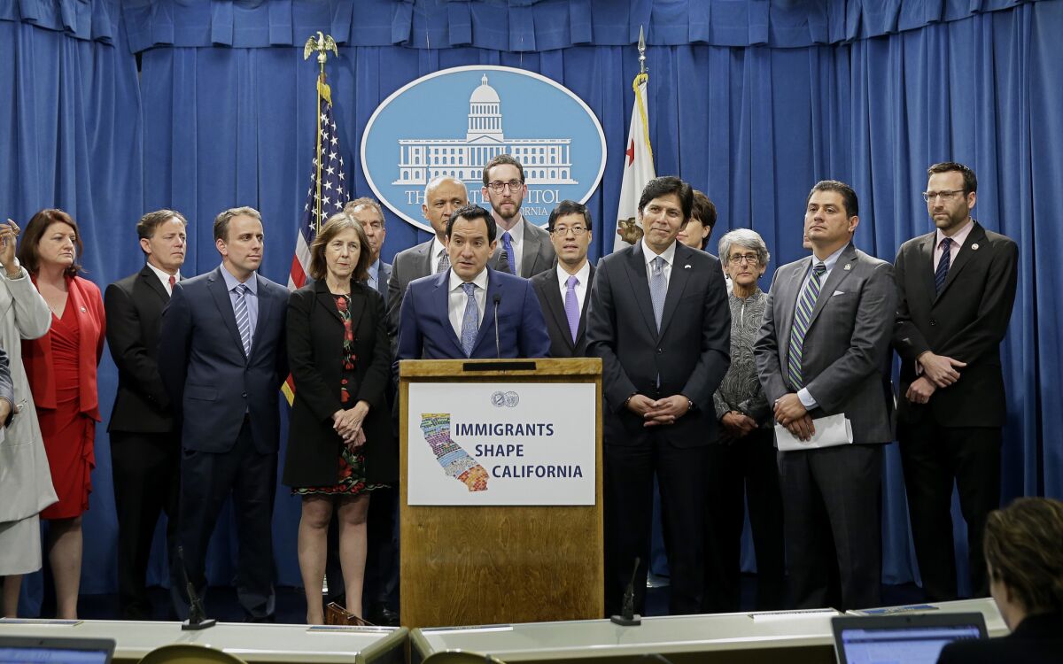 Assembly Speaker Anthony Rendon, D-Paramount, center, discusses a pair of proposed measures to protect immigrants, during a news conference in Sacramento, Calif., Monday, Dec. 5, 2016.