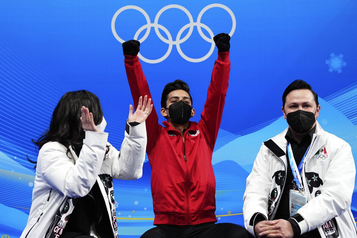 Donovan Carrillo raises his arms in celebration at the 2022 Olympics.