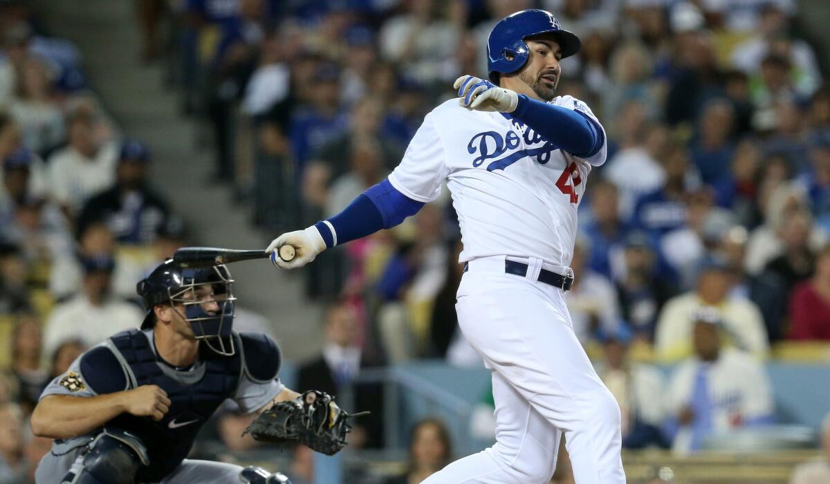 Dodgers first baseman Adrian Gonzalez follows through on a run-scoring single against the Mariners in a game April 15.