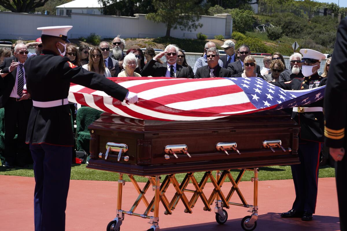 Members of the U.S. Marine honor team prepare to fold the U.S. flag that covered PFC John Middleswart’s casket