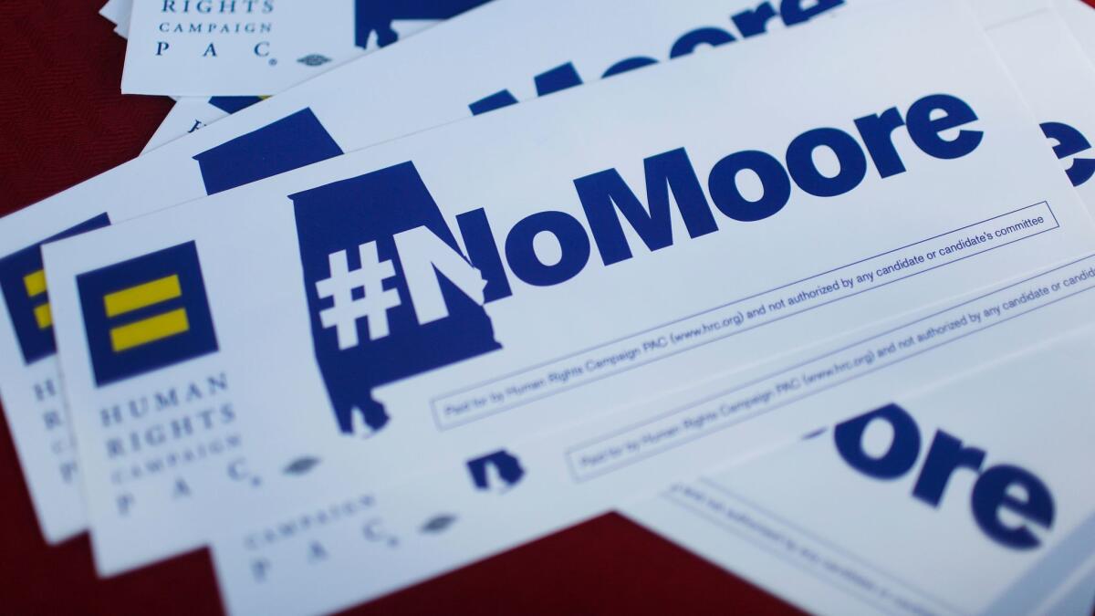 Bumper stickers saying "#NoMoore" sit on a table during a protest of Republican Senate candidate Roy Moore in Montgomery, Ala., on Nov. 28.