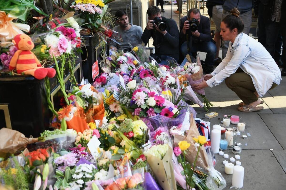 People attending a vigil for Monday's suicide-attack victims brought flowers to St. Ann Square in Manchester, England, on Tuesday.