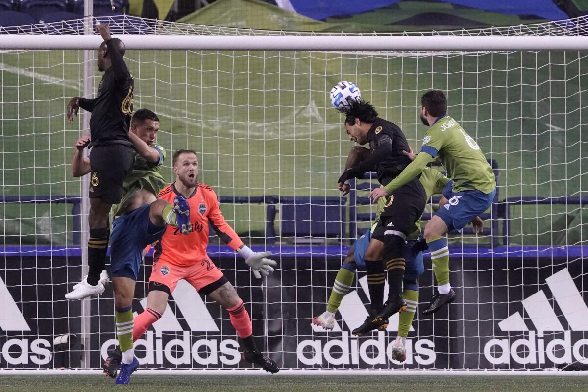 LAFC's Carlos Vela heads the ball in front of Seattle Sounders goalkeeper Stefan Frei.
