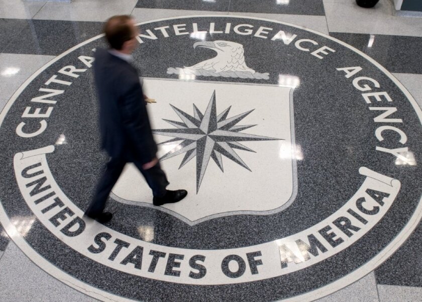 A man is seen crossing the Central Intelligence Agency logo in the lobby of CIA Headquarters in Langley, Va.