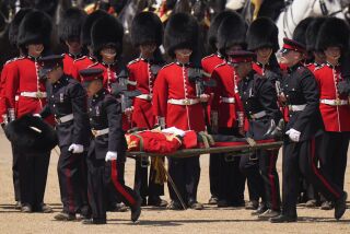 Un soldado es trasladado en camilla tras desmayarse debido al intenso calor durante el Colonel's Review, en Londres, el sábado 10 de junio de 2023. (Foto AP/Alberto Pezzali)