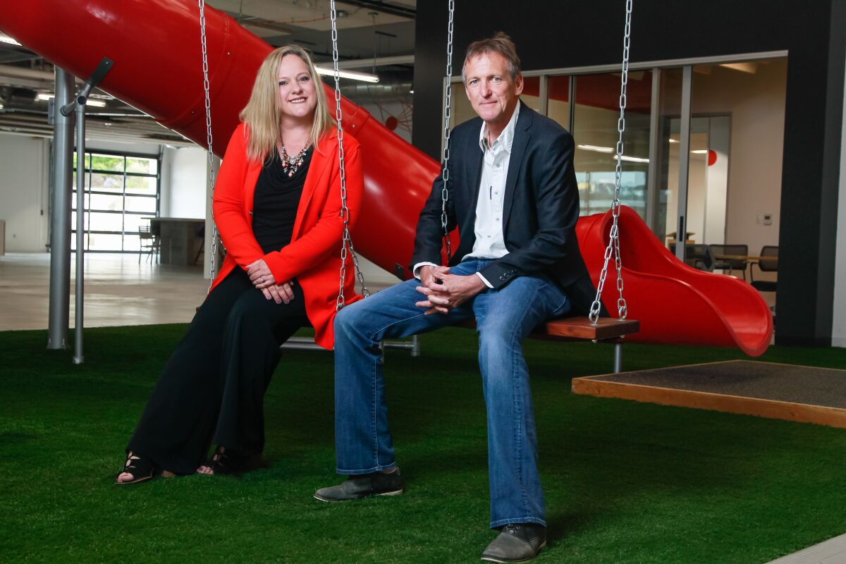 Silvia Mah (left), and Mike Krenn (right), who will be the new president and CEO of the merger between the San Diego Venture Group and Connect, at the new offices.