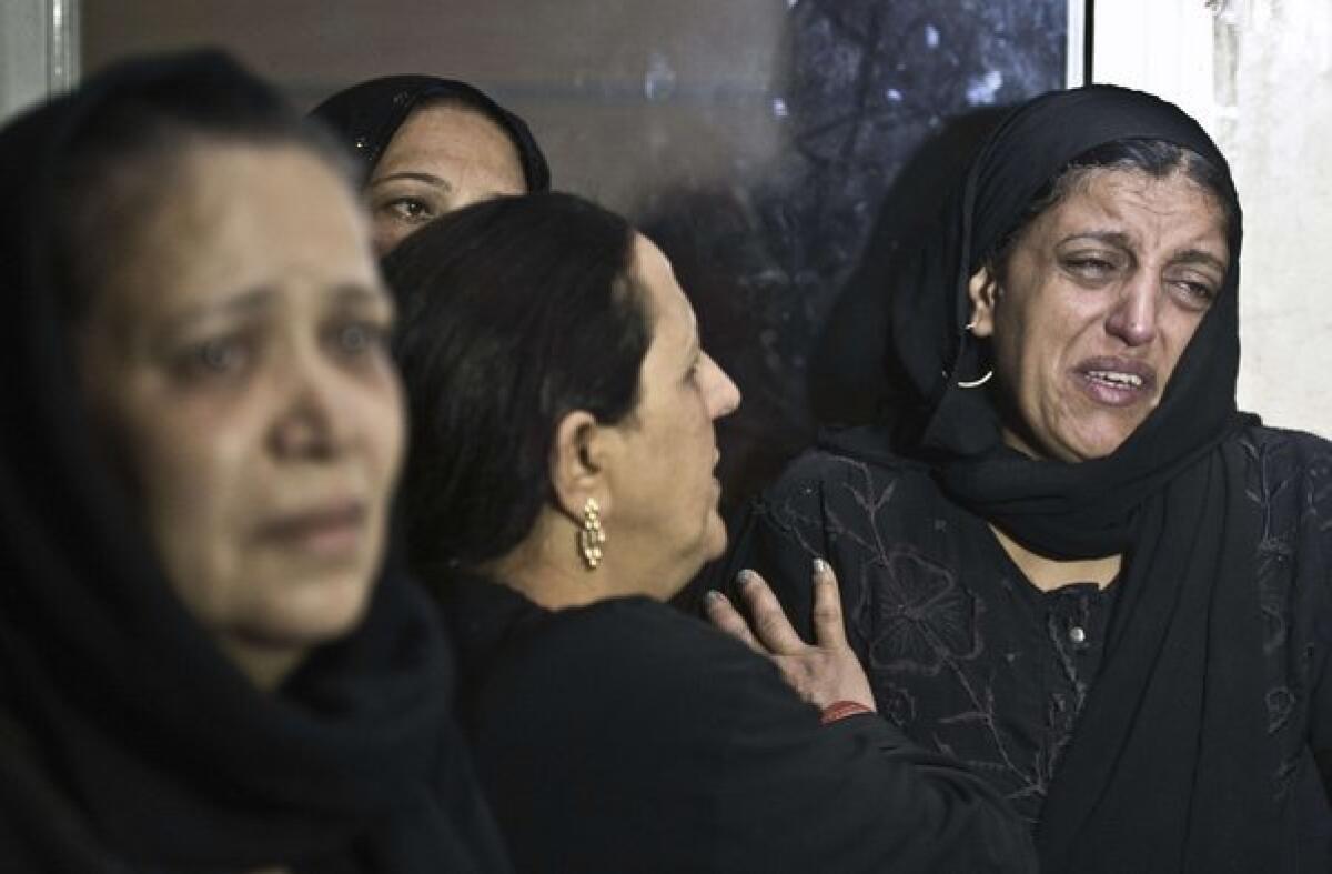 Egyptian women, some in tears, gather inside the Virgin Mary Coptic Christian church in Cairo after gunmen on a motorbike killed four people.