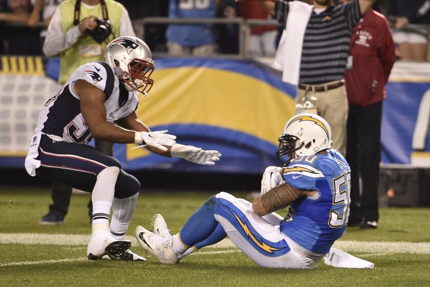 San Diego Chargers inside linebacker Manti Te'o, right, holds on to an interception as New England Patriots running back Shane Vereen looks on during the second half in an NFL football game Sunday in San Diego.